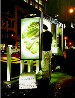 distance- hyperrealism acrylic painting by artist painter Gerard Boersma showing a man late at night placing a telephone call in a Verizon telephonebooth in New York, street scene, cityscape