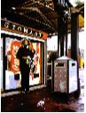 automat- hyperrealism painting by artist Gerard Boersma showing a woman waiting for train in front of an coca cola vending machine at central station Leeuwarden