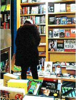 catalogue- hyperrealism painting by artist Gerard Boersma showing woman behind computer searching books in public library leeuwarden
