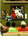entombment- hyperrealism acrylic painting by artist painter Gerard Boersma showing woman tourguide giving tour in Getty Museum Los Angeles in front of paintings by Peter Paul Rubens, cross fall