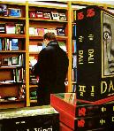 art books- hyperrealism painting by artist Gerard Boersma showing man with books in local bookstore, book in foreground about salvador dali