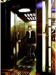 elevator- hyperrealism acrylic painting by artist painter Gerard Boersma showing woman in elevator designed by rem koolhaas
