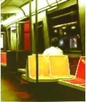 underground - hyperrealism painting by artist Gerard Boersma showing a man riding an empty subway car in New York
