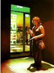 textmessage- hyperrealism acrylic painting by artist painter Gerard Boersma showing a woman sending a textmessage at night in Haarlem