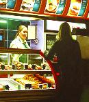 counter- hyperrealism acrylic painting by artist painter Gerard Boersma showing a woman ordering something by counter grand central station Amsterdam