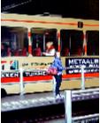 Tram Platform- hyperrealism public transport painting of people a woman waiting for her tram on platform in The Hague by artist Gerard Boersma