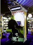 Catalogue- hyperrealism painting by artist Gerard Boersma showing woman behind computer searching books in public library Leeuwarden
