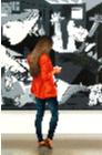 Hello- museum and art within art hyperrealism painting by Gerard Boersma of a boy fiddling with phone in front of painting by Roy Lichtenstein