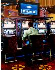 Las Vegas Slot Machines- stores and interiors- hyperrealism  painting of man hitting the slot machines in Las Vegas hotel lobby by artist Gerard Boersma