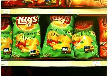 Lays- hyperrealism acrylic still life painting by artist Gerard Boersma showing bags of lays chips in supermarket