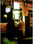 parking automat- hyperrealism acrylic painting by artist painter Gerard Boersma showing a nightscene cityscape of a man in front of parking automat, street scene. Leeuwarden, Zaailand