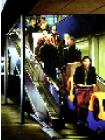 product- hyperrealism acrylic painting by artist painter Gerard Boersma showing people leaving ikea with escalator