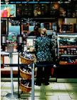 Woman At Counter- hyperrealism acrylic painting by artist painter Gerard Boersma showing a woman at the counter of  coffee bar (Coffee Bean and Tea Leaf)